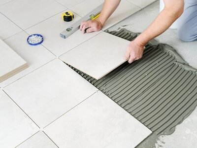 contractor-installing-ceramic-tile-flooring